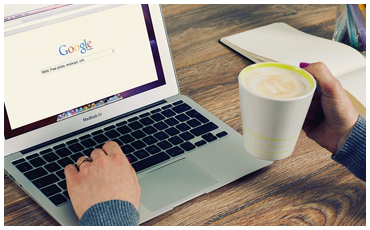 Person using laptop with a coffee cup on a desk symbolizing Finance Law